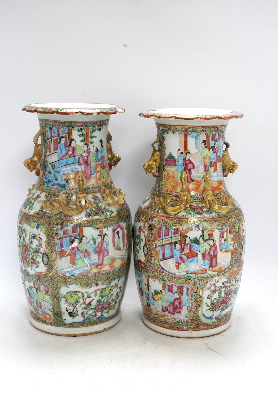A pair of 19th century Chinese Canton famille rose vases, 36cm high. Condition - poor